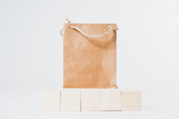 Sticker - Paper bag on a light background. Concept of using ecological things. Using paper bags instead of plastic. Recycling and environmental protection.