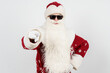 © Dzmitry - Santa Claus in dark glasses points his finger towards the camera. Isolated background