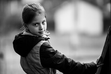 Wall Mural - Portrait of little girl in the village. Black and white photo.