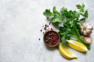 Wall Mural - Culinary background with assortment of spices : lemon, garlic, pepper,parsley. Top view with copy space.