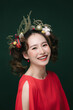 © MaaHoo Studio/Stocksy - Portrait of young woman with pine branches and Christmas decorations on her hair