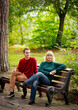 © khanfus - Beautiful woman,blonde,middle-aged,with her son,sitting on a bench and talking