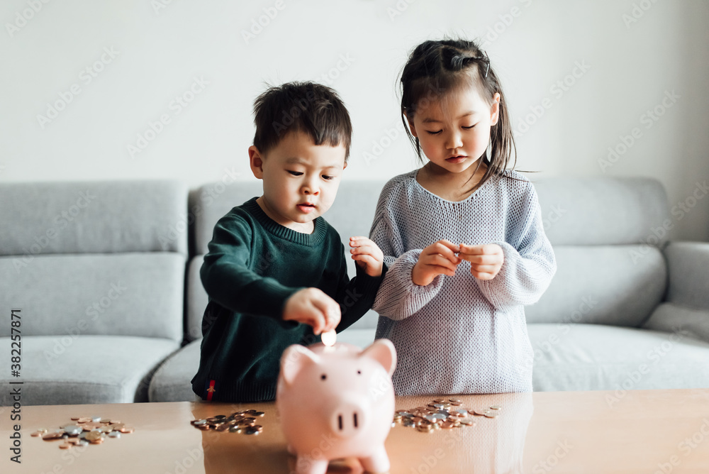Family saving money in a piggybank Stock Photo | Adobe Stock