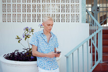 Stylish Blond Man Using Mobile Phone In Miami