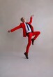 © Liliya Rodnikova/Stocksy - Graceful male in vibrant red suit in studio