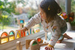© Lauren Lee/Stocksy - Little girl playing with blocks