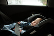 © Lyuba Burakova/Stocksy - Two month baby sleeping in safety seat in car