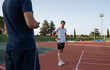 © Milles Studio/Stocksy - Tired runner listening to trainer on track