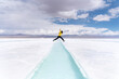 © Bisual Studio/Stocksy - Woman jumping on a salt flat