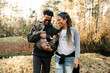 © Kristen Curette Photography LLC/Stocksy - An African American couple walking out in nature with their french bulldog.