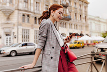 Red Haired Woman In Stylish Outfit Chatting On Phone