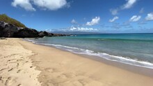 Mokulei'a Beach Cove In Maui, Hawaii With Sand And Gentle Waves