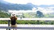 © Chaiwat - Asian woman on the mountain see view panorama the beautiful nature landscape of mountain views and fog on vacation travel. with action camera for take picture.