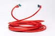 Coiled red ethernet cable with two RJ45 plugs