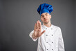 © Cipri Suciu  - Young male dressed in a white chef suit showing stop sign