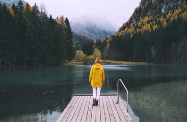 Wall Mural - Woman looking at mountain lake in Slovenia. Travel Europe.