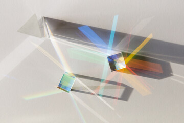 glass geometric figures prisms with light diffraction of spectrum colors and complex reflection with
