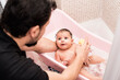 © Antonio Recena - Father cleaning little baby at home bathtub