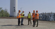 © Framestock - Workers in masks walking near wind turbine