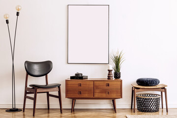 Wall Mural - Stylish and retro living room with design vintage wooden commode, chair, footrest, table lamp and elegant personal accessories. Mock up poster map on the wall. Template. Home decor.