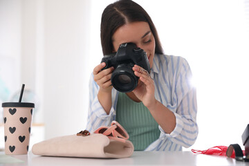 Poster - Young photographer taking picture of accessories indoors