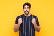 © luismolinero - Young handsome man with beard over isolated yellow background celebrating a victory