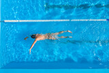 Fototapeta  - Man training in swimming pool, top view