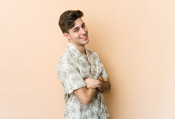 Wall Mural - Young caucasian man isolated on beige background happy, smiling and cheerful.