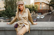 © Svetlana Sokolova - Outdoor image of  elegant european woman walking in  autumn  city . Beige  cap and jacket. stylish accessories. .
