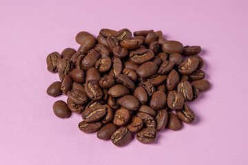 Coffee beans on a pink background. Coffee concept.