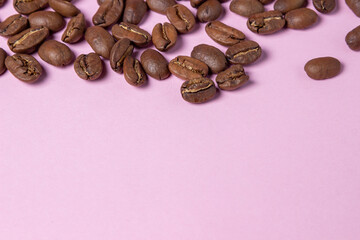 Coffee beans on a pink background. Coffee concept.