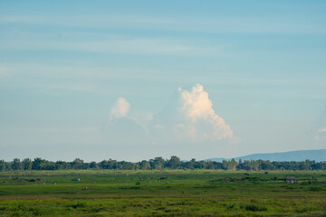 Blue sky and white cloud over land background