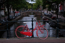 Red Bicycle On A Bridge In Amsterdam