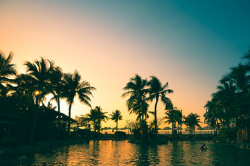 Canvas Print - sunset on swimming pool sea view and coconut tree