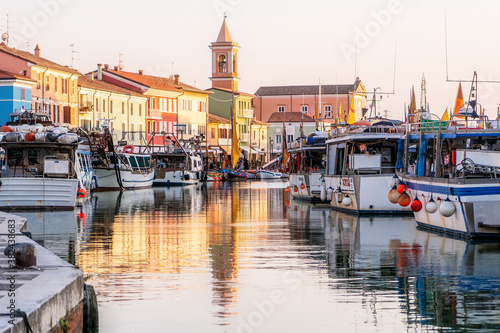 Cuadros en Lienzo Colourful fishing boat in the Leonardo's canal harbor of Cesenatico, Emilia Roma