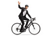 © Ljupco Smokovski - Profile shot of a businessman riding a bicycle to work and waving at camera