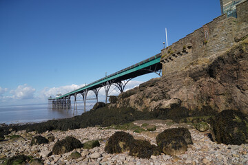 Wall Mural - Panoramic photo of Clevedon Pier in somerset showing iron structure against blue sky