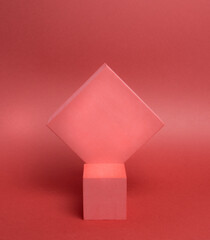 Photo of a bright podium (pedestal) of two cubes on a paper background. In pink, with gradient. Advertising place. Blank product stand and abstract background with light.