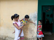 © Dream Lover/Stocksy - Twin girls and a teenage girl making fun and play
