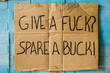 © Kristen Curette Photography LLC/Stocksy - Give a Fuck / Spare a Buck hand written sign on cardboard