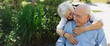 © Rob and Julia Campbell/Stocksy - Happy, fun loving elderly couple outside in garden using wheelchair