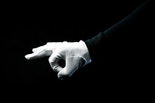 A Hand Wearing White Glove On Black Background Showing ZERO Sign