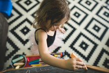 Bird's Eye View Of Girl Drawing With Chalk