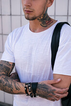 Close-up Of Young Man In White T-shirt With American Eagle Tattoo On Neck