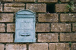 © Adrian Cotiga/Stocksy - Blue mailbox on a wall