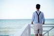 © Pixel Stories/Stocksy - Young man standing on pier