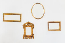 Empty Golden Frames On A White Wall