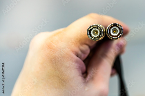 Cuadros en Lienzo cable coax for signal transmission cable television end in male hands close-up
