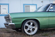 © Carolyn Lagattuta/Stocksy - Old school green ranch wagon with big, silver wheels