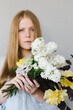 © Caleb  Thal/Stocksy - Redheaded Female Holding A Bouquet of Flowers